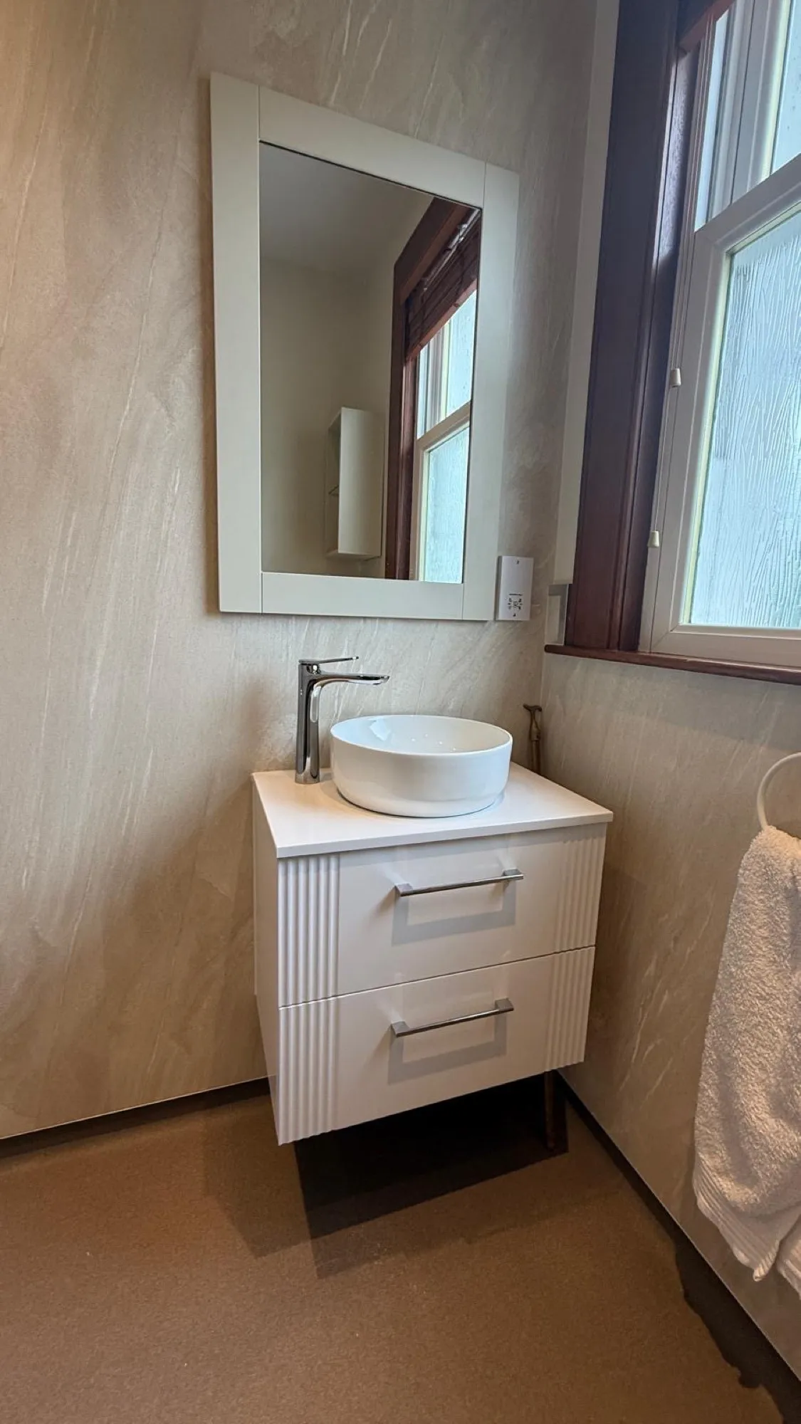 Countertop basin and mirror in a finished bathroom