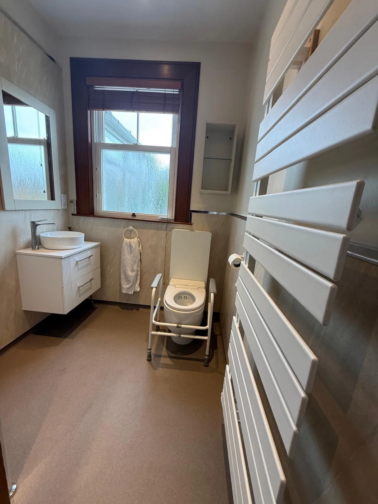Shower room with a window, vanity unit and shower chair