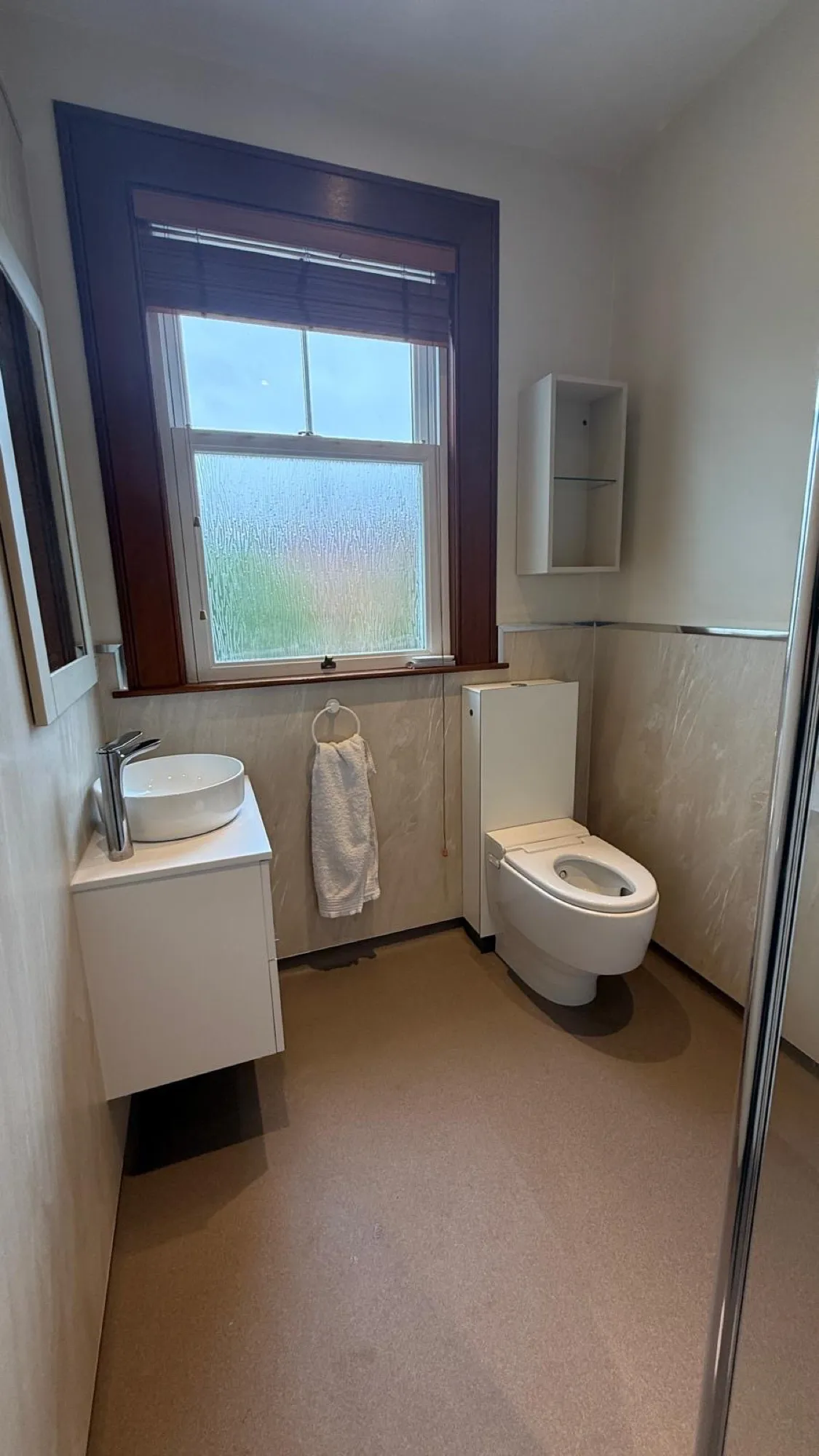 White bathroom with close-coupled toilet and vanity basin