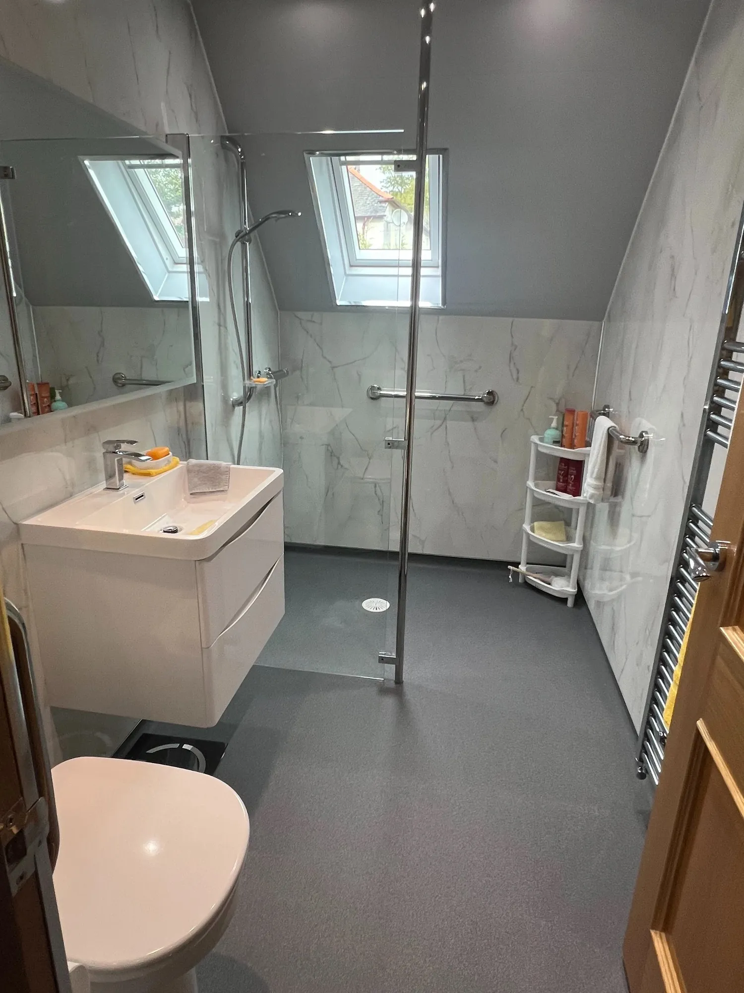 Attic wet room with a skylight and glass screen