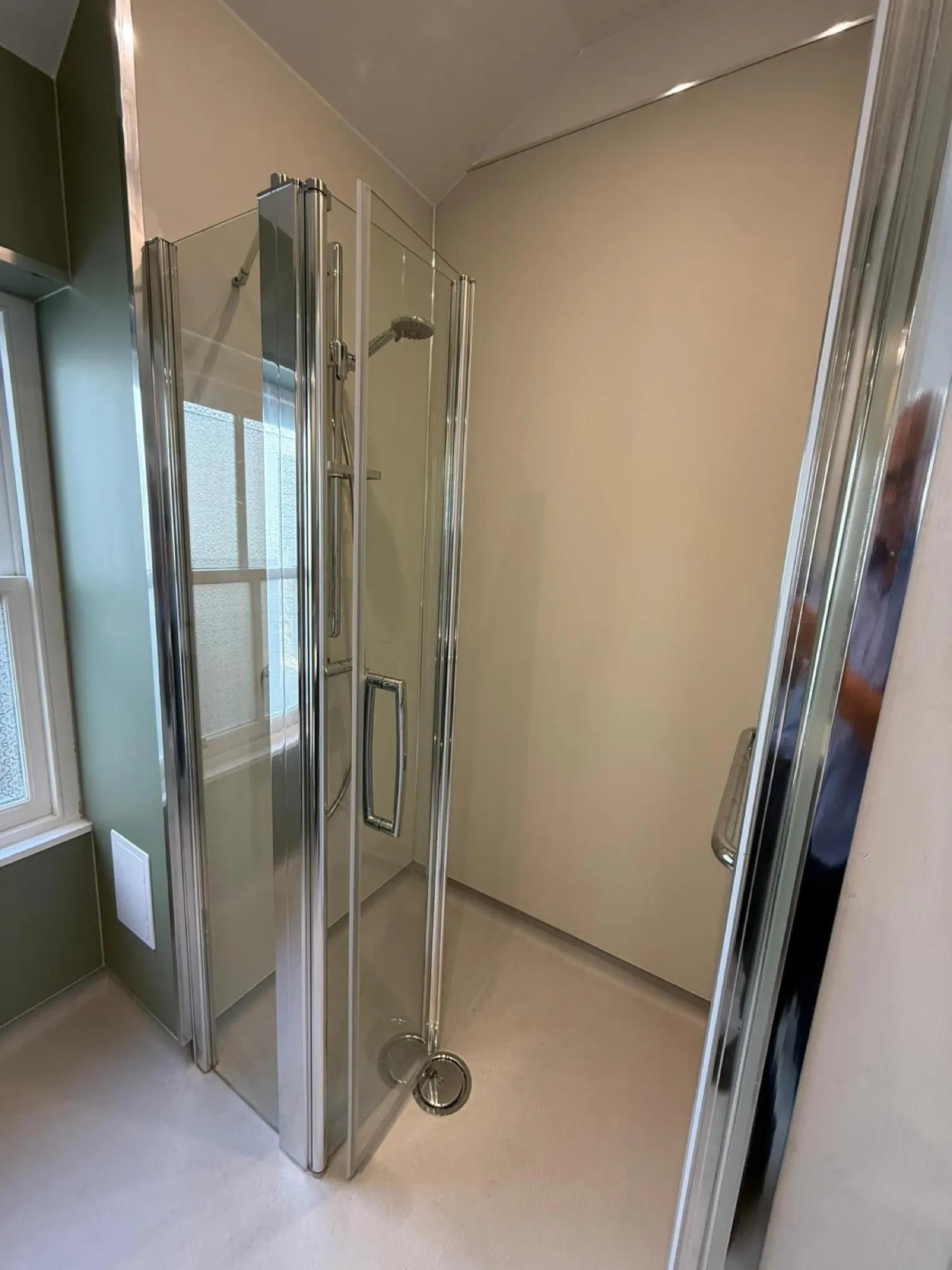 Corner glass shower enclosure in a finished bathroom