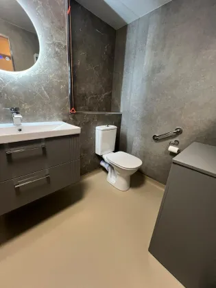 A completed accessible bathroom with discreet support rails