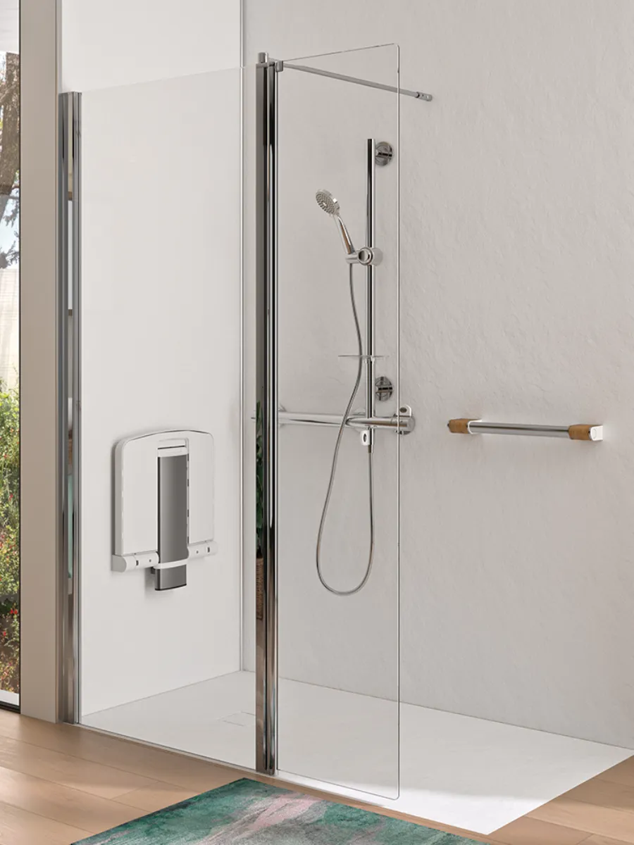 A walk-in shower with a low-profile tray, wide entrance, folding seat and support rails