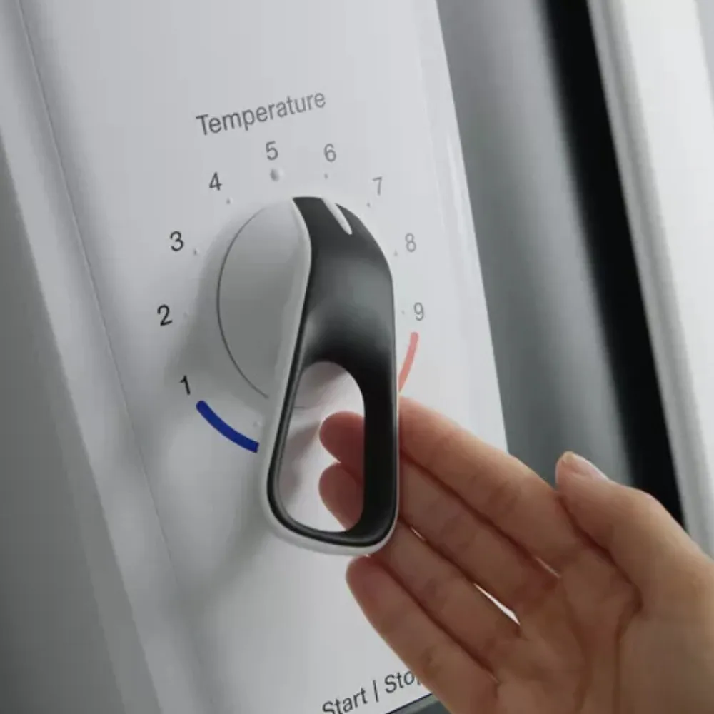 A hand operating a large lever temperature control