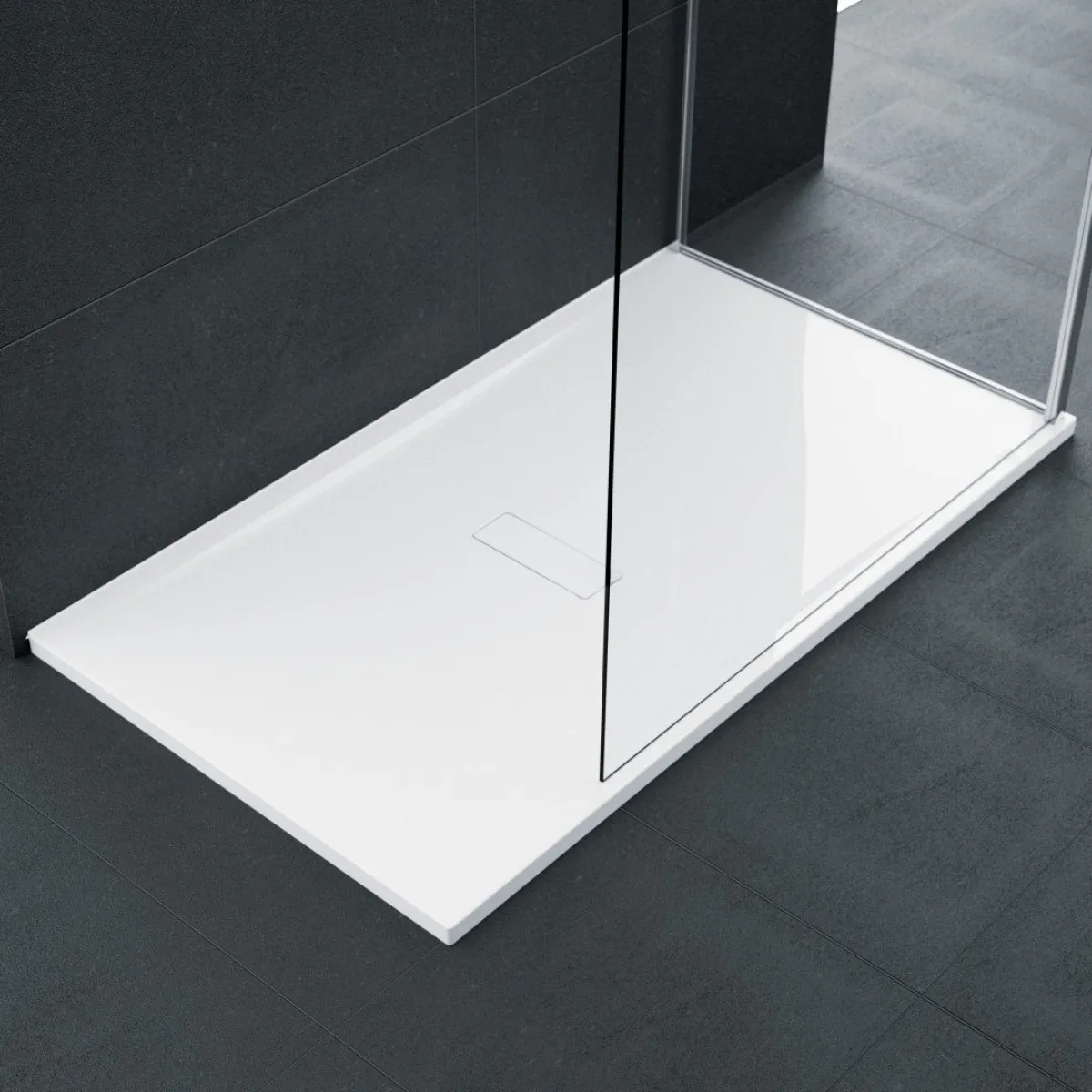 A low-profile white shower tray against dark grey tiles