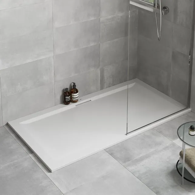 A low-profile rectangular shower tray in a grey bathroom