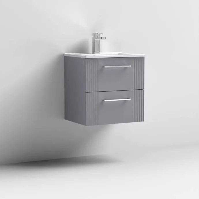A grey wall-hung vanity unit with fluted drawer fronts